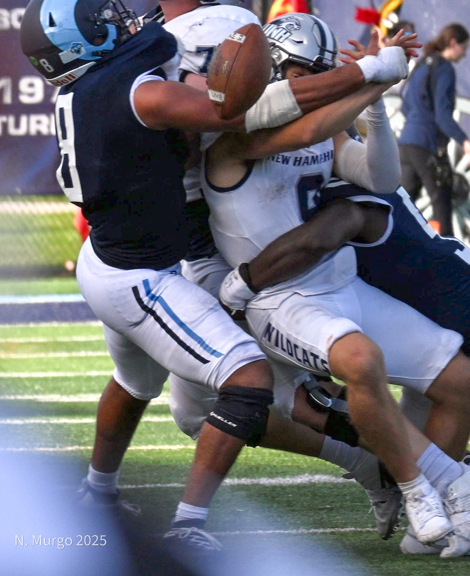 Rhode Island defenders Moses Meus and A.J. Pena combine on a fourth-quarter strip sack against New Hampshire, October 12, 2025.